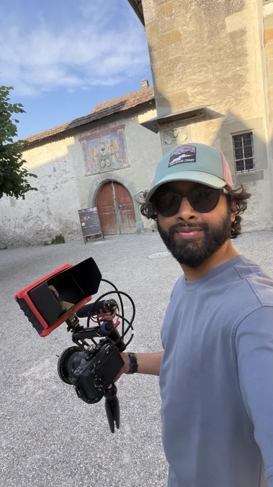 Compact cinema rig outside a frescoed courtyard